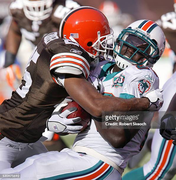 Miami Dolphins running back Ronnie Brown gets tackled during the game against the Cleveland Browns at Cleveland Browns Stadium in Cleveland Ohio on...