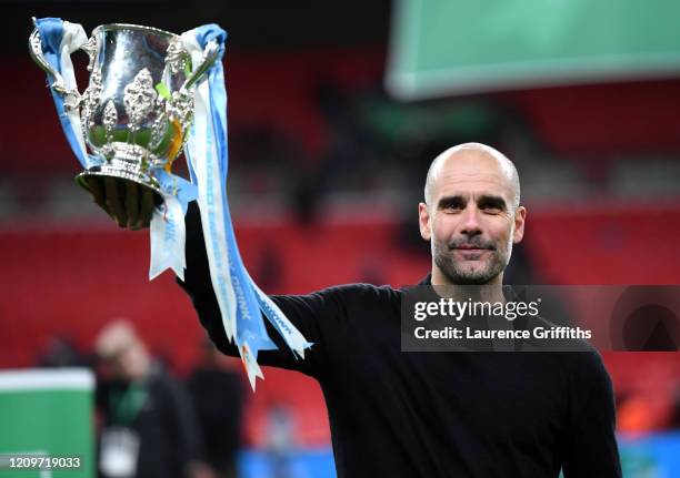 Pep Guardiola, Manager of Manchester City celebrates with trophy following his sides victory in the Carabao Cup Final between Aston Villa and...