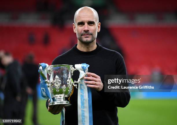 Pep Guardiola, Manager of Manchester City celebrates with trophy following his sides victory in the Carabao Cup Final between Aston Villa and...