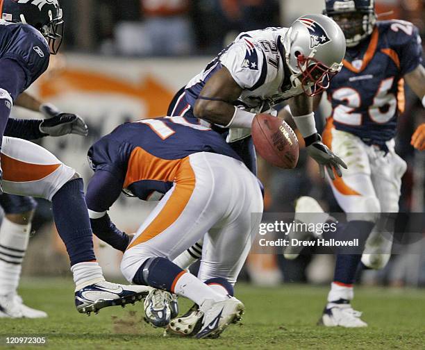 New England kick returner Ellis Hobbs fumbles the ball after getting hit by Denver Broncos punter Todd Sauerbrun Saturday, January 14, 2006 at...