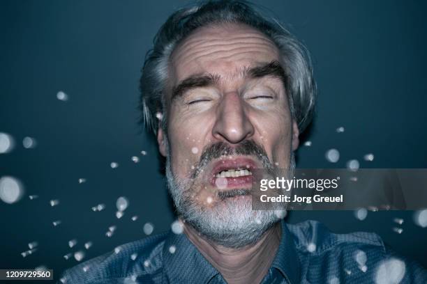 sneezing man - spit stock pictures, royalty-free photos & images