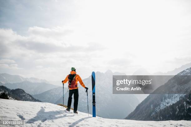 hiker enjoying the views in the mountains before skiing back to the valley - ski holidays stock pictures, royalty-free photos & images