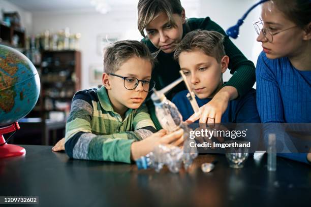 mother teaching kids about greenhouse effect - science measurement stock pictures, royalty-free photos & images