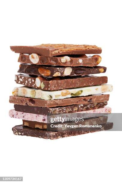 a stack of different chocolate isolated on white background - schokolade stock-fotos und bilder
