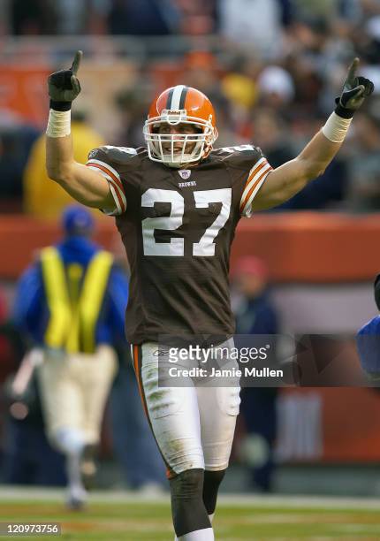Cleveland Browns Defensive Back, Brian Russell, raises his arms in victory after team mate Brodney Pool intercepts the last play of the game against...