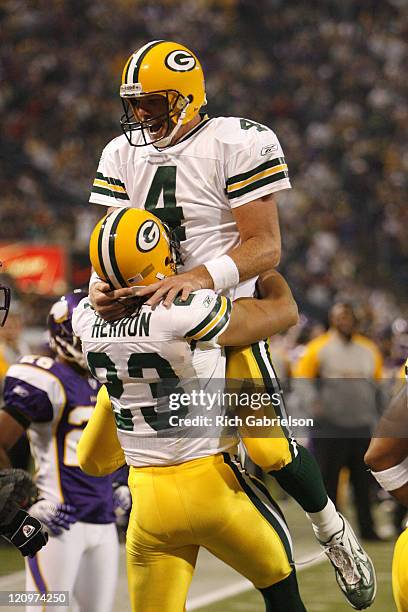 Green Bay Packers quarterback Brett Favre celebrates a touchdown pass with Green Bay Packers running back Noah Herron. The Green Bay Packers defeated...