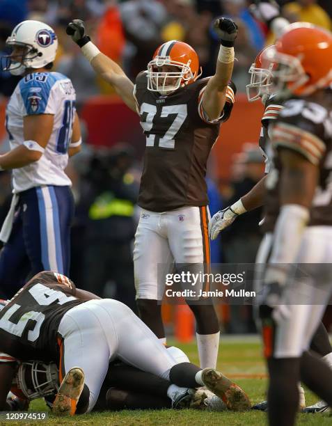 Cleveland Browns Defensive Back, Brian Russell, raises his arms in victory after team mate Brodney Pool intercepts the last play of the game against...