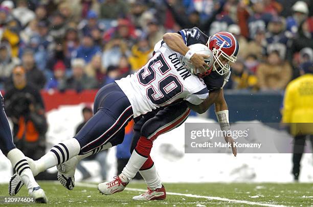 Buffalo Bills quarterback JP Losman is hit by linebacker Rosevelt Colvin after throwing a pass in a game against the New England Patriots at Ralph...