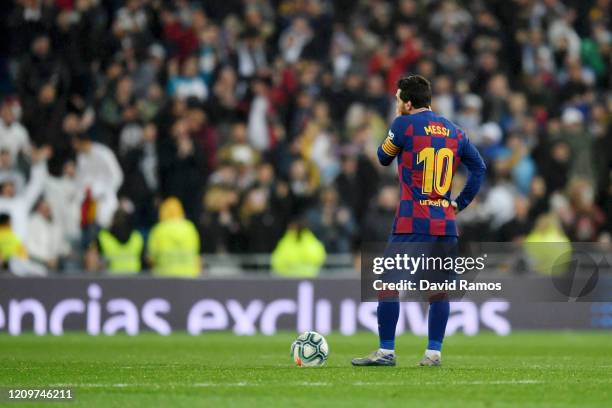 Lionel Messi of FC Barcelona looks dejected after conceding his sides second goal during the Liga match between Real Madrid CF and FC Barcelona at...