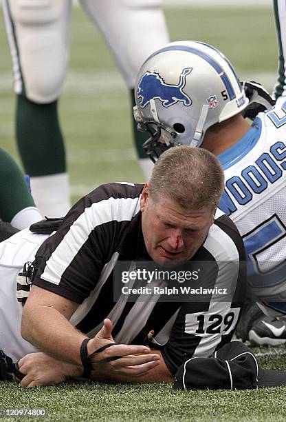 Umpire Bill Schuster is run over during the New York Jets 31 to 24 victory over the Detroit Lions on October 22, 2006 at Giants Stadium in East...