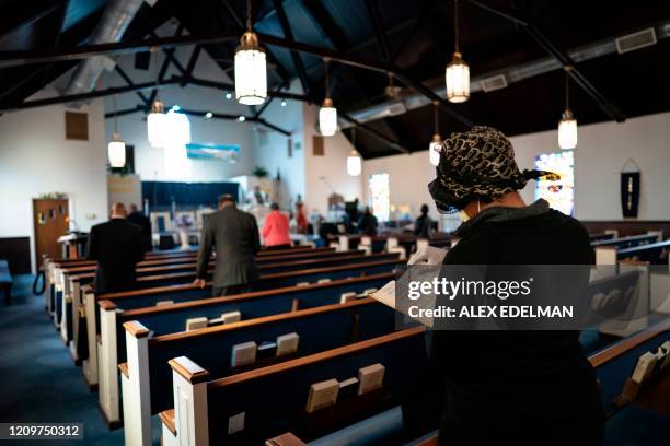 Congregants attend Sunday morning Easter services at The Friendship Baptist Church on April 12, 2020 in Baltimore, Maryland. - The church pastor,...