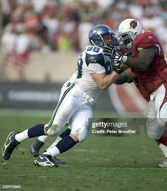 Grant Wistrom defensive end for the Seattle Seahawks is blocked by Leonard Davis in a game against the Arizona Cardinals at Sun Devil Stadium in...