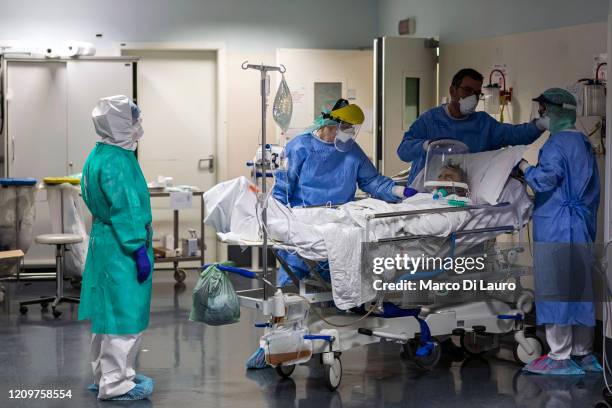 Nurses attend a COVID-19 patient at the Pope John XXIII Hospital on April 7, 2020 in Bergamo, Italy. The number of new COVID-19 cases appears to be...