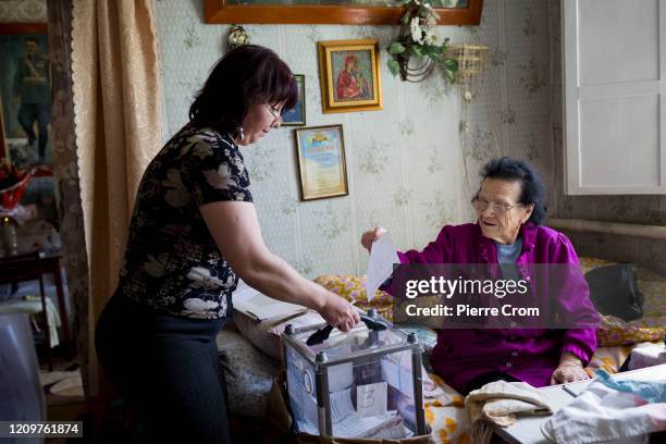 Mobile team of pro-Russian separatists pressures disable and elderly local residents to cast a ballot during a staged referendum backed by Russia on...