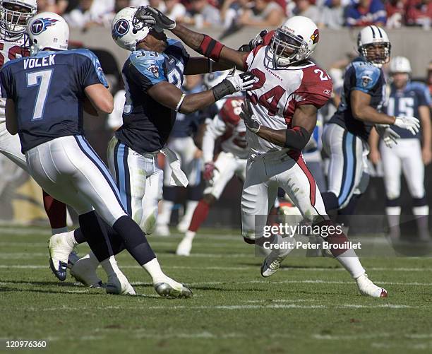 Adrian Wilson strong safety for the Arizona Cardinals rips the helmet off Jarrett Payton while pass rushing in a game against the Tennessee Titans at...