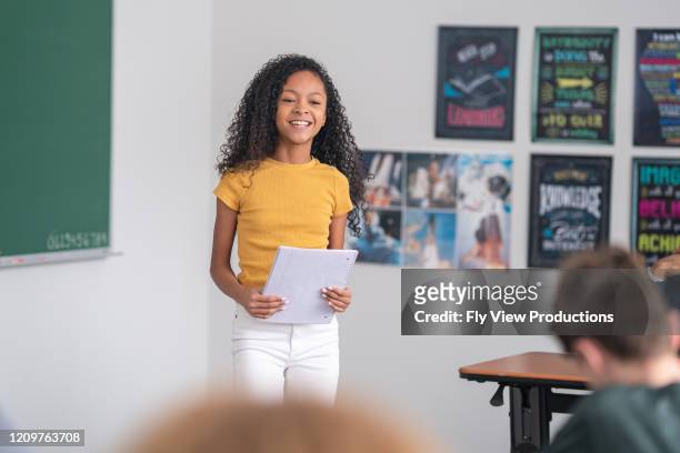 a junior high girl presents to her classmates - speech stock pictures, royalty-free photos & images