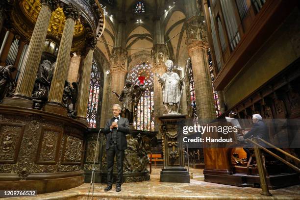 In this handout photo provided by DECCA Records, opera singer Andrea Bocelli performs his Easter concert at the Duomo on April 12, 2020 in Milan,...