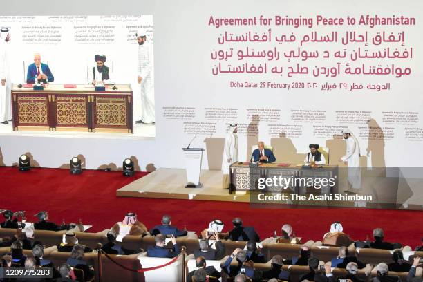 Taliban co-founder Mullah Abdul Ghani Baradar and U.S. Special Representative for Afghanistan Reconciliation Zalmay Khalilzad sign the peace...