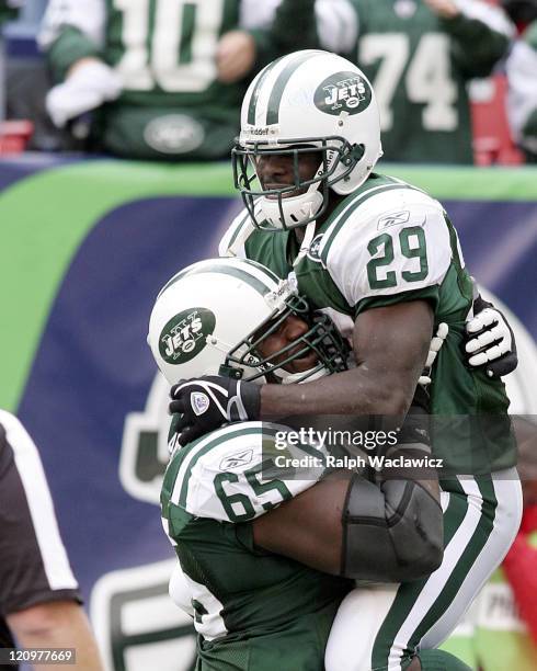 New York Jets rookie runningback Leon Washington jumps into the arms of offensive guard Brandon Moore after a touchdown during their 31 to 24 victory...