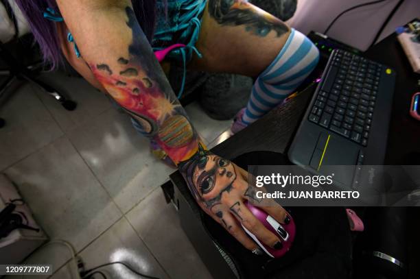 Colombian Girl-cam model Angela Cianuro performs during a webcam session at her apartment in Bogota on April 12, 2020. - Eroticism and sex online are...