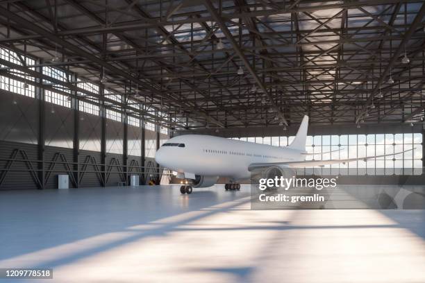 flugzeughangar mit flugzeug - flugzeug hangar stock-fotos und bilder