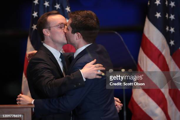 Former South Bend, Indiana Mayor Pete Buttigieg kisses his husband Chasten after Chasten introduced him before a speech where he announced he was...