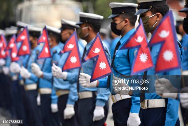 Nepalese Traffic Police personnel hold National Flag and sung national anthem as Prime Minister KP Sharma Oli urged to play national anthem for...