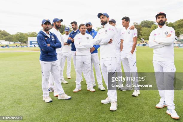 Captain Virat Kohli of India and his team mates look dejected after their loss on day three of the Second Test match between New Zealand and India at...