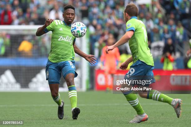 Kelvin Leerdam runs for the ball alongside Harrison Shipp of Seattle Sounders in the second half against the Chicago Fire during their game at...