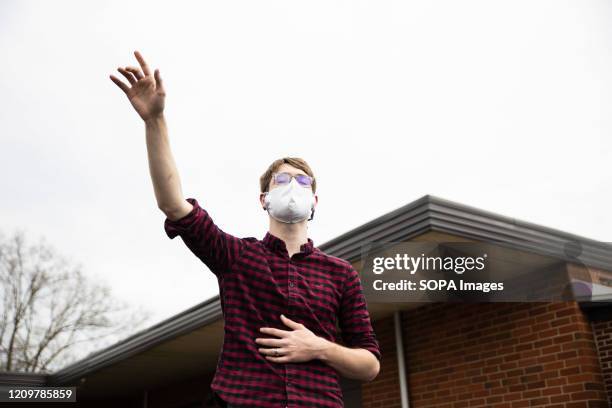 Devotee worshipping while wearing a face mask as a preventive measure against covid19 virus during Easter Sunday church service. Church members...