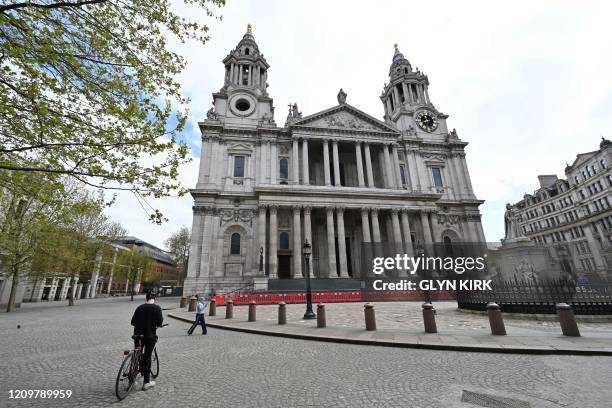 The entrance to St Paul's Cathedral is seen fenced off as tourists stay away on the bank holiday Monday in London on April 13 as life in Britain...