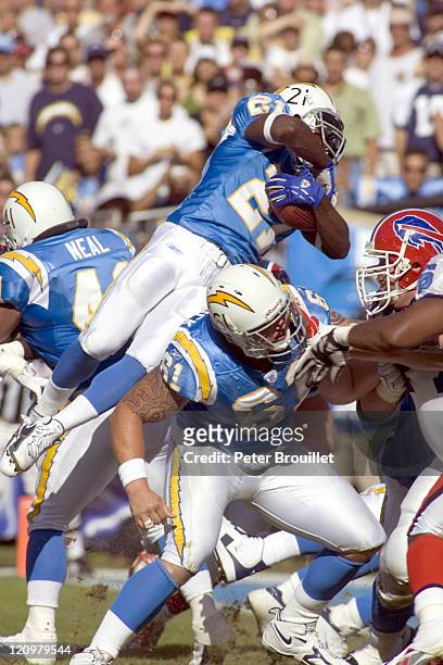 LaDainian Tomlinson running back for the San Diego Chargers leaps over the line of scrimmage for a short gain in a game against the Buffalo Bills at...
