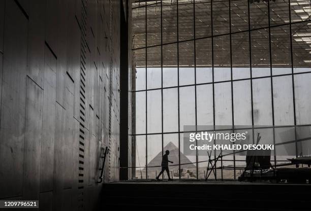 Picture taken on April 13 shows a view of the Great pyramid of Khafre seen through the scaffolding on the Grand Egyptian Museum , which is currently...