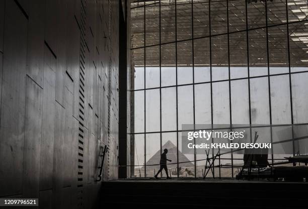 Picture taken on April 13 shows a view of the Great pyramid of Khafre seen through the scaffolding on the Grand Egyptian Museum , which is currently...