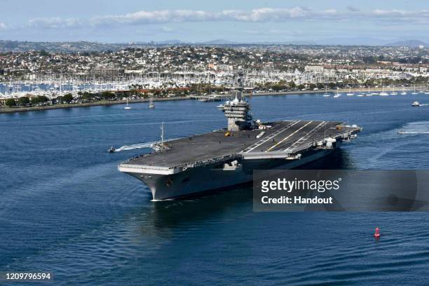 In this handout released by the U.S. Navy, The aircraft carrier USS Theodore Roosevelt leaves its San Diego homeport Jan. 17, 2020. The Theodore...
