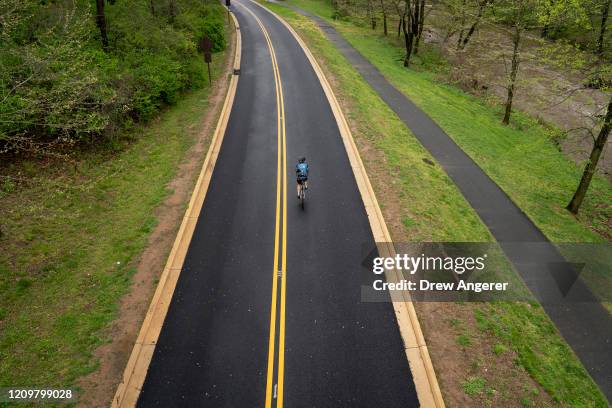 Cyclist rides along Beach Drive on April 13, 2020 in Washington, DC. The District of Columbia city government has closed portions of Beach Drive and...