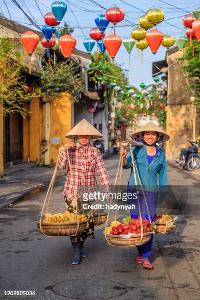 vietnamese women selling tropical fruits, old town in hoi an city, vietnam - vietnam street food stock pictures, royalty-free photos & images