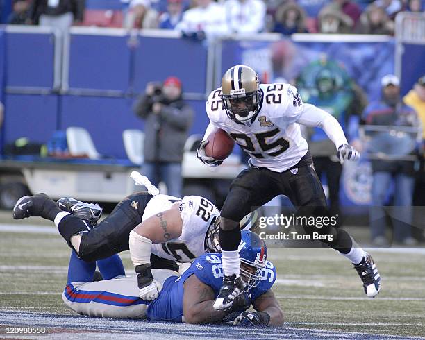 New Orleans Saints running back Reggie Bush breaking away from New York Giants defensive tackle Fred Robbins Reggie had 20 carries for 126 yards and...