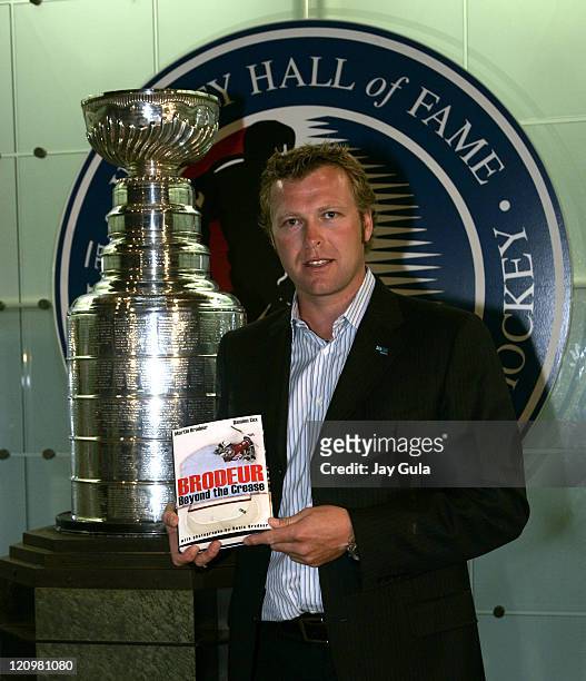 Martin Brodeur of the New Jersey Devils poses in front of the Stanley Cup at the launching of his book "Brodeur, Beyond the Crease" in the Great Hall...