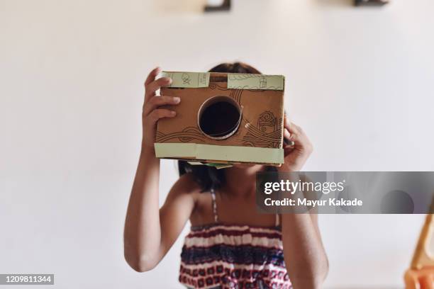 girl playing with her homemade camera - toy camera stock pictures, royalty-free photos & images