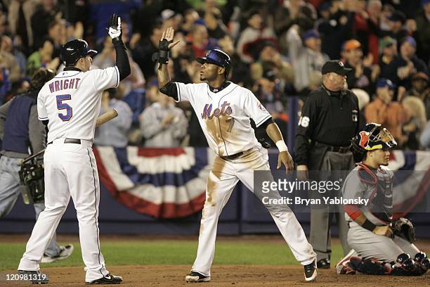 New York Mets David Wright greeting Jose Reyes at home plate after scoring on home run by Carlos Delgado during game 2 of the MLB National League...