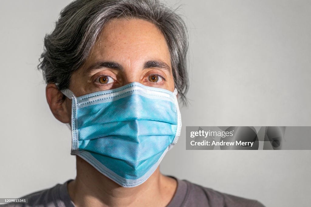 Woman wearing a surgical mask, protective face mask against infectious diseases like coronavirus and influenza