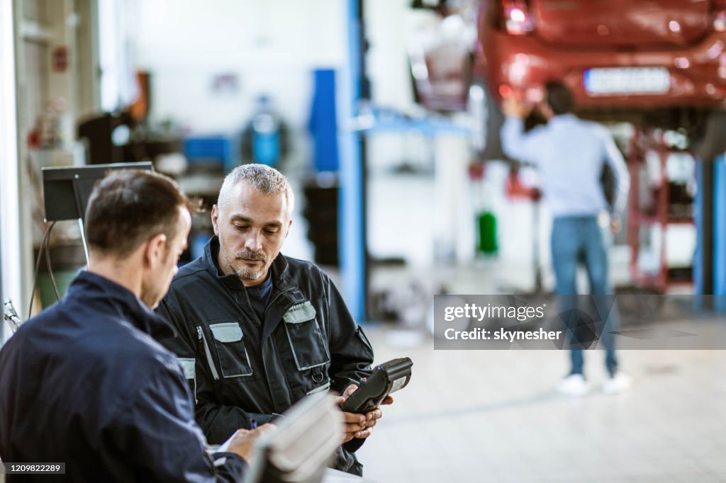 Repair Shop Roles Mid Adult Manual Workers Working In A Repair Shop High-Res Stock Photo ...