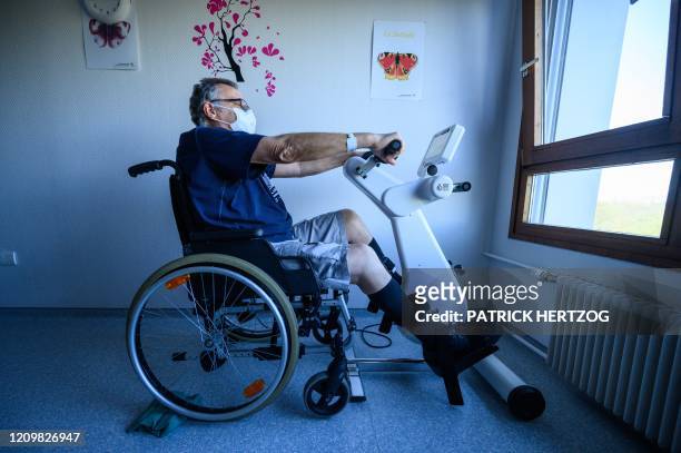 Patient undergoes a rehabilitation program as he recovers after being infected by the novel coronavirus COVID-19, at a hospital in...