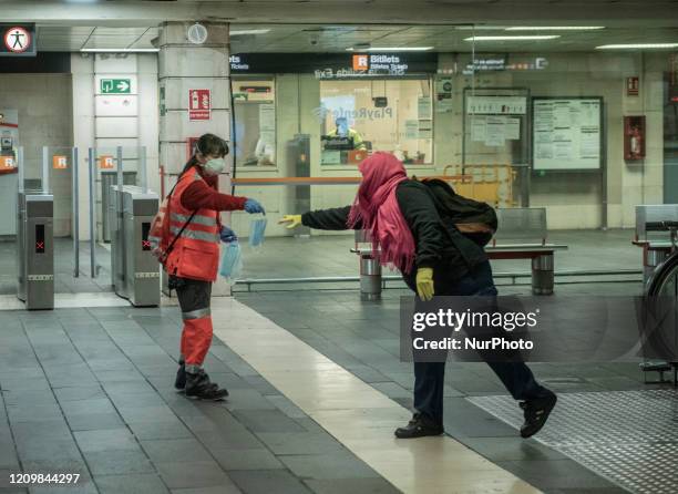 The Red Cross volunteers handing Out Masks in underground station in Barcelona, Spain on April 2020.
