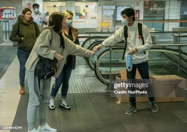 The Red Cross volunteers handing Out Masks in underground station in Barcelona, Spain on April 2020.