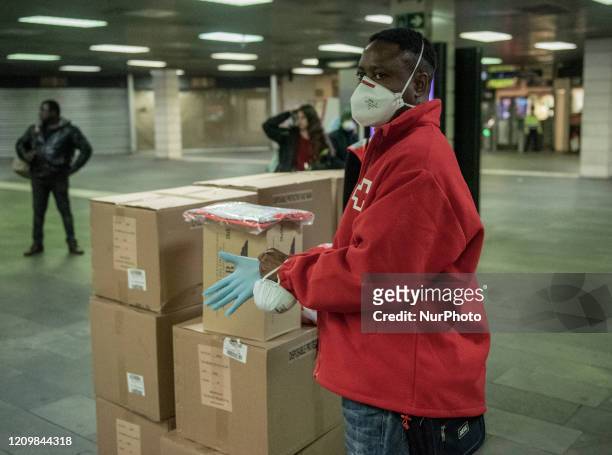 The Red Cross volunteers handing Out Masks in underground station in Barcelona, Spain on April 2020.
