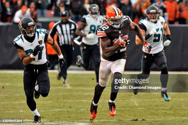 Wide receiver Josh Gordon of the Cleveland Browns carries the ball on a 95-yard touchdown in the fourth quarter of a game against the Jacksonville...
