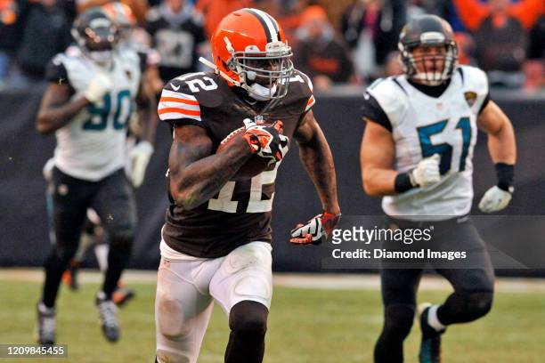 Wide receiver Josh Gordon of the Cleveland Browns carries the ball on a 95-yard touchdown in the fourth quarter of a game against the Jacksonville...