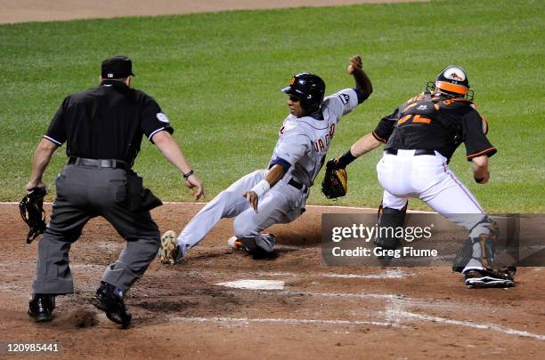 Austin Jackson of the Detroit Tigers is tagged out at home plate in the fourth inning by Matt Wieters of the Baltimore Orioles at Oriole Park at...
